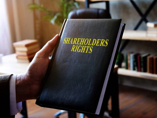 a man hodling a Shareholder Rights books